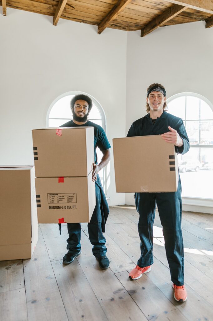 Two movers holding boxes