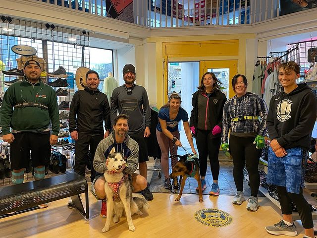 Group of people and a dog in Athletic Soles store after a run
